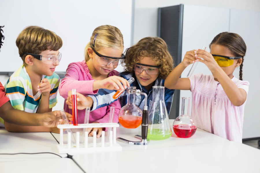 Children (ages 3–12) doing a chemistry experiment in a lab