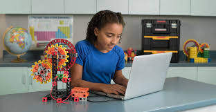 Students (ages 9–12) coding during a STEM session